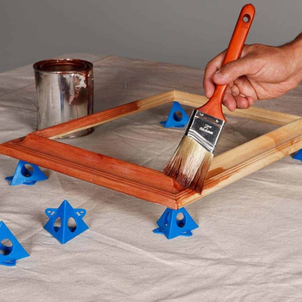 Paint pyramids hold cabinet doors in place to make staining easier.